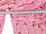 a close up of a pink dress with sequins on it