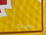 a painting of a red and yellow soccer jersey on a yellow tray