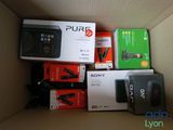 a lot of electronic items in a box on the floor