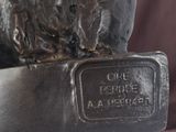 a statue of a bear that is on a plaque