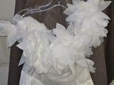 a wedding dress hanging on a hanger in a room