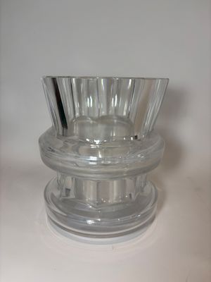 a clear glass vase on a table with a white background