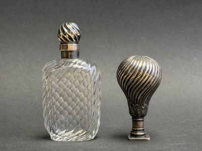 two bottles of perfume sitting next to each other on a table