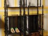 two shelves with shoes on them in the corner of a room