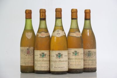 six bottles of wine are lined up on a table