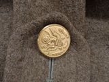 a gold coin sitting on top of a brown jacket