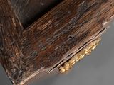 a close up of a piece of wood with gold decorations on it