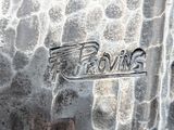 a close up of a silver plate with a logo on it