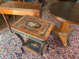 three chairs and a table in a room with a rug on the floor