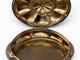 an antique silver plate with a flower design on it