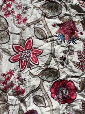 an image of a close up of a quilt with flowers on it