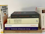 several books are stacked on top of each other on a table