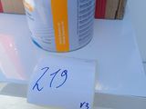 a can of paint on a table with a price tag
