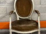 a chair that is sitting in front of a brick wall
