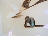 un dessin représentant un oiseau perché sur une branche d'arbre