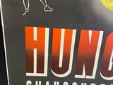 a poster of a man hitting a tennis ball with a racquet