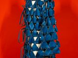 a mannequin made of blue and white ribbons on a stand
