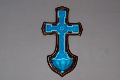a blue cross hanging on the wall of a church