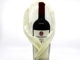 a bottle of red wine wrapped in a plastic bag