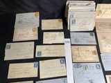 some old letters and envelopes sitting on a table with a black background