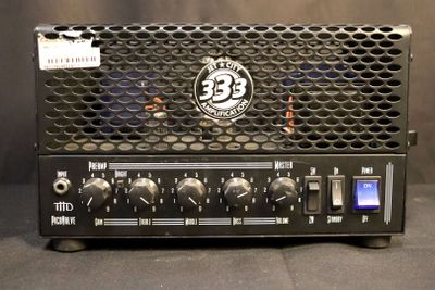 an image of a close up of a guitar amplifier on a table