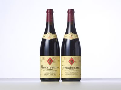 two bottles of red wine sitting on top of a table