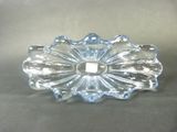 clear glass candle holder with a flower design on top of it