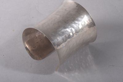 a close up of a silver ring on a white surface