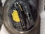 a lot of tools that are sitting on the rim of a car