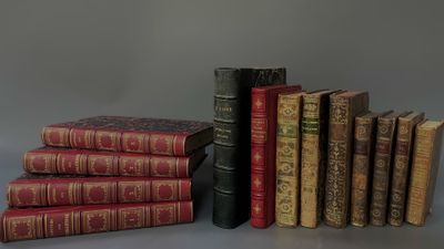 several old books are stacked on top of each other on a table