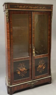 une paire de vitrines anciennes en bois avec des portes vitrées de chaque côté