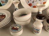 a lot of plates and cups that are sitting on a table
