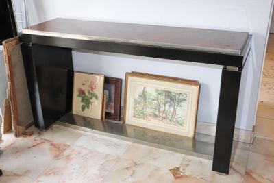 a picture of a black console table with pictures on it