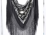 an image of a black and white photo of a shawl hanging on a wall