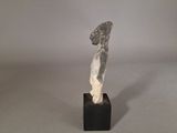 statue of a woman in profile on a black base