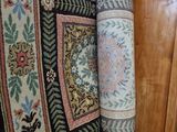 two rugs on the floor next to each other