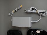 two controllers and a charger sitting on a table