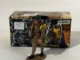 the figurine is standing next to a box with a picture of a soldier on it