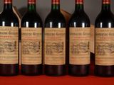 six bottles of wine are lined up on a table