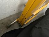 a black bag sitting on the ground next to a yellow gate
