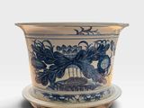 a blue and white bowl with a saucer on it