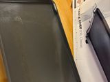 a black pan sitting on top of a table next to a pair of scissors
