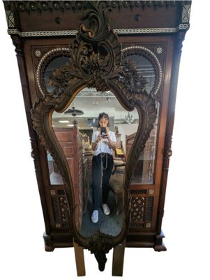 a woman taking a picture of herself in a mirror