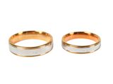 two gold and silver wedding rings on a white background