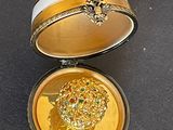 a box with a gold coin inside of it on a table