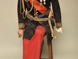 a statue of a man in a military uniform sitting on a chair