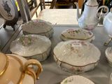 a lot of plates and bowls on the table