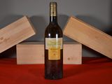 a bottle of wine sitting on a table next to two wooden boxes