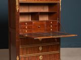 an antique writing desk with drawers and a marble top