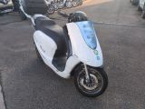 a scooter that is parked in the parking lot